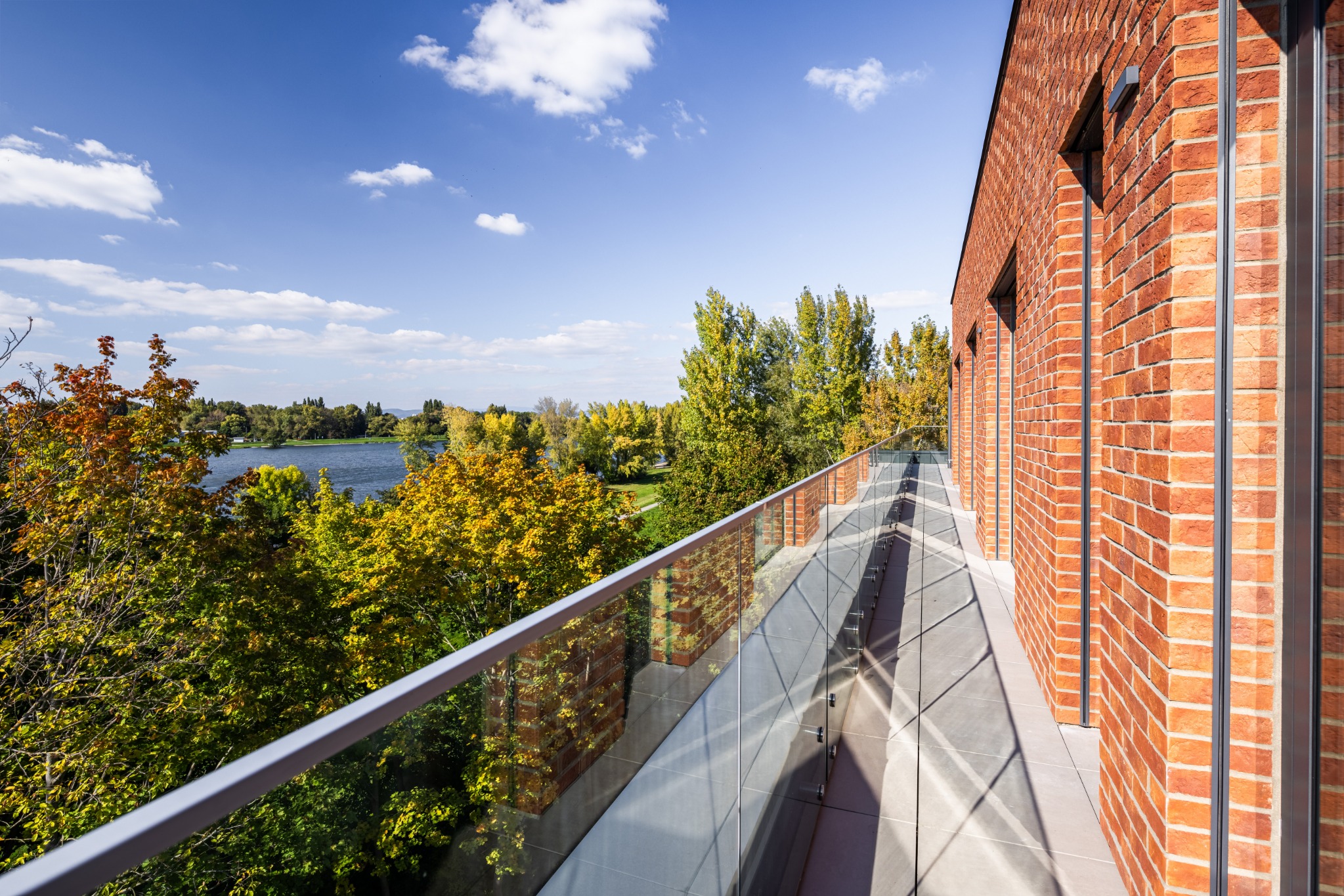 Terrace beside the brick façade overlooking the river at The Riverview 3BR Luxury Residence Piešťany
